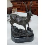 A bronze of a stag on rocky outcropping mounted on slate base height 26cm