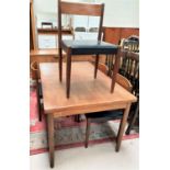 A Danish teak dining suite comprising extending dining table, 4 chairs with black leather