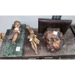 A carved wall shelf in form of a cherub's head, a wooden gilt figure of a cherub wall hanging with 3