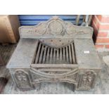 A cast iron fireplace with grate