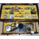 A jewellery box containing various costume jewellery items, brooches, bangles etc