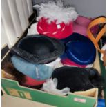 A large selection of 1980's hats decorated with feathers; etc.