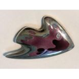 Georg Jensen:  a modernist silver brooch in the form of a stylized fish with body in shades of