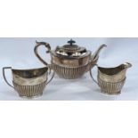 A two piece set of silver milk jug and sugar bowl monogrammed with ribbed decoration, marks