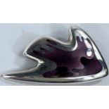 Georg Jensen:  a silver brooch in the form of a stylized fish in varying shades of purple enamel,