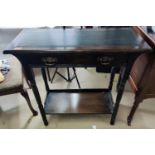 An Edwardian stained mahogany writing table with inset leather top and frieze drawer, on turned legs