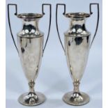 A pair of hallmarked silver vases with weighted bases, of tapering trophy form.