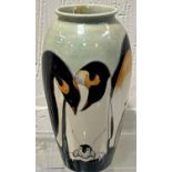 A modern Moorcroft tapering 'Penguin' vase decorated with penguins and chicks against a celadon