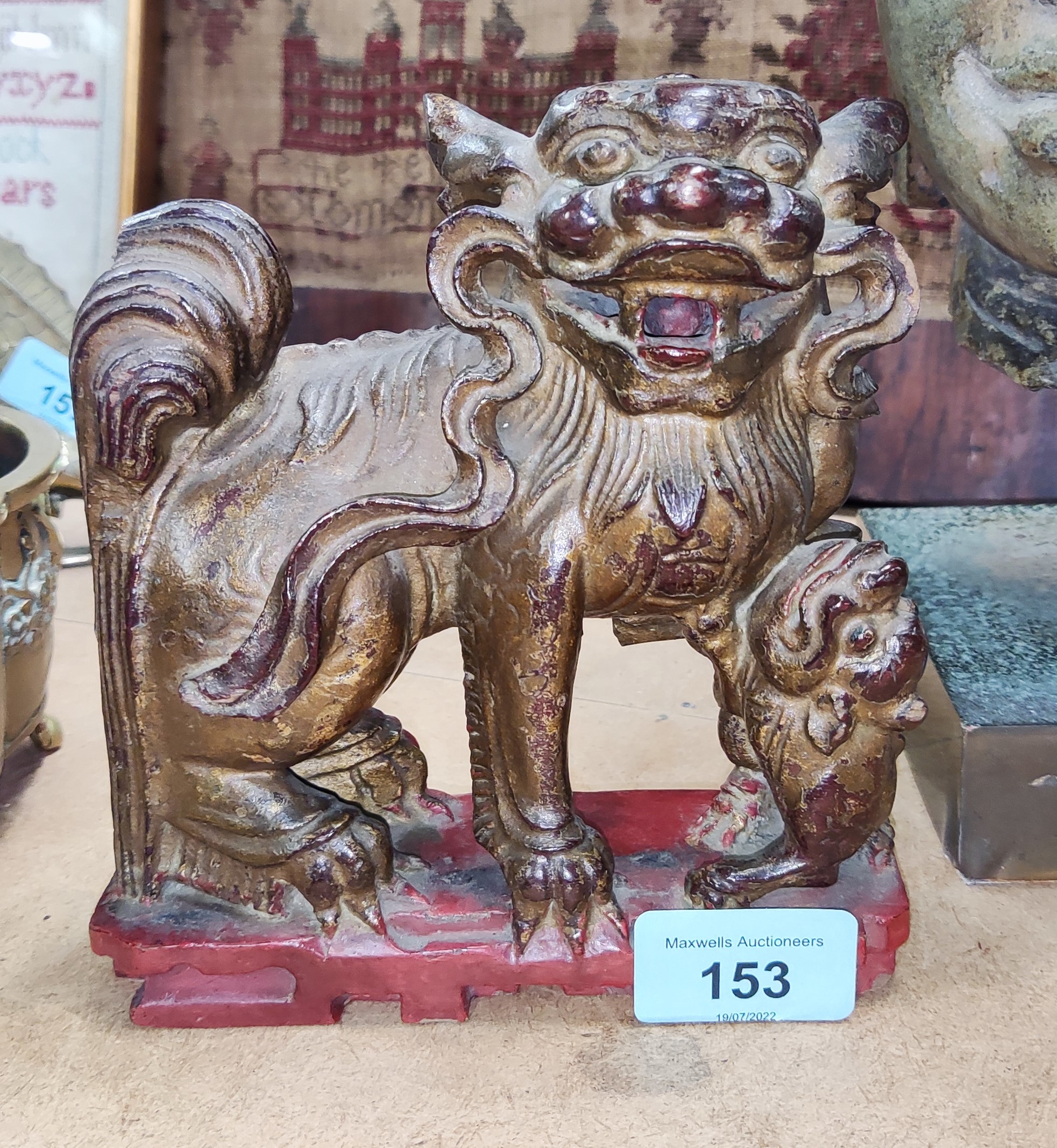 A Chinese carved wood figure of mythical animal with gilt highlights, length 15cm