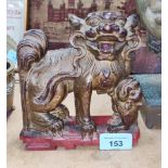 A Chinese carved wood figure of mythical animal with gilt highlights, length 15cm