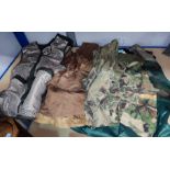 Four various hunting vests in camouflage colours