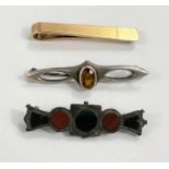 A silver gilt tie clip, an arts and crafts hallmarked silver brooch set with citrine and a stone