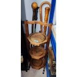 An oak 3 tier folding cake stand; 4 walking sticks; 6 aneroid barometer; a selection of treen