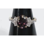 An 18ct hallmarked gold lady's dress ring set with purple oval Bekily colour change garnet and