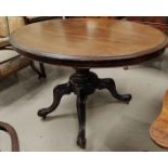 A Victorian mahogany dining table with oval tilt top, on turned column and 3 splay feet