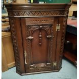 An Oak reproduction wall hanging corner cupboard