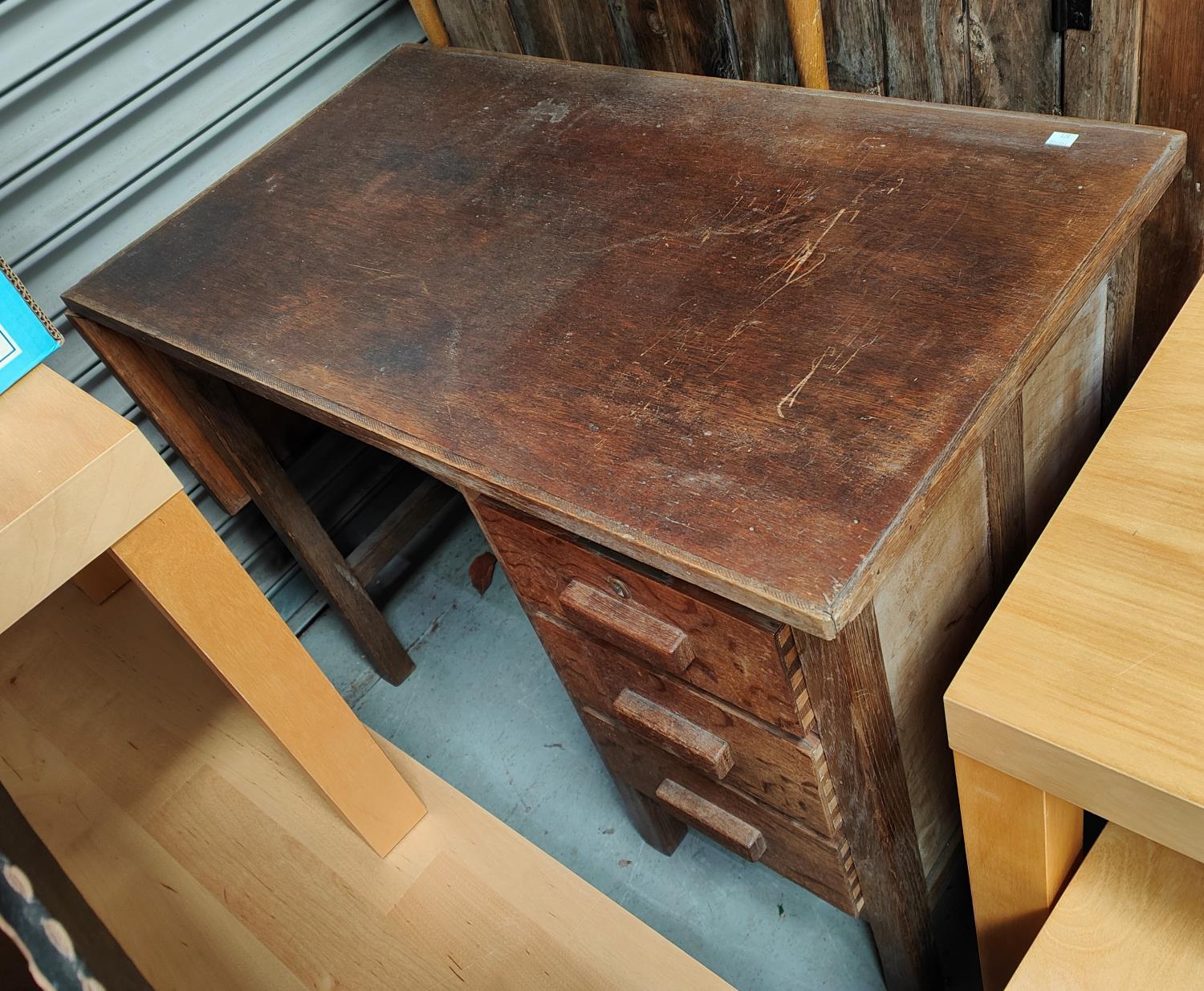 A 1930's oak desk with single pedestal and hinged flap