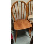 A set of 4 Ercol elm and beech dining chairs with hoop and stick backs