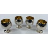 A set 4 pedestal brandy cups in parcel gilt silver, maker A.T.C., Birmingham 3 x 1973, 1 x 1973,
