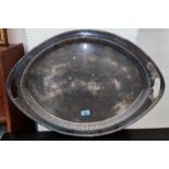 A large oval shaped silver plated galley tray with integral handles length 64cm