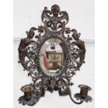 A bronzed and gilt mirror with double candle sconce and pierced decoration, height 33cm