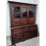 A mid 18th century oak country made dresser/press cupboard with moulded and dentil cornice, the