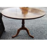 A 19th century oak tilt top occasional table on pedestal with three splay feet