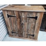 A stripped pine side cabinet with 2 doors