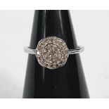 A 9 carat hallmarked white gold dress ring with Argyle diamonds in circular 2 tier setting, 0.3