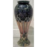 A modern Moorcroft inverted baluster vase decorated with stylised tall flowers, impressed and