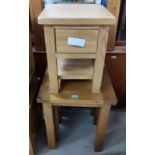 A nest of two light oak graduating square occasional tables and a single drawer bedside cabinet