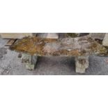 A reconstituted stone curved garden bench