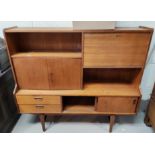 A mid 20th century teak highline sideboard double cupboard, fall front, 2 drawers and sliding