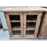 A Victorian style stripped pine display cabinet/bookcase, double glazed doors enclosing shelves 94 x