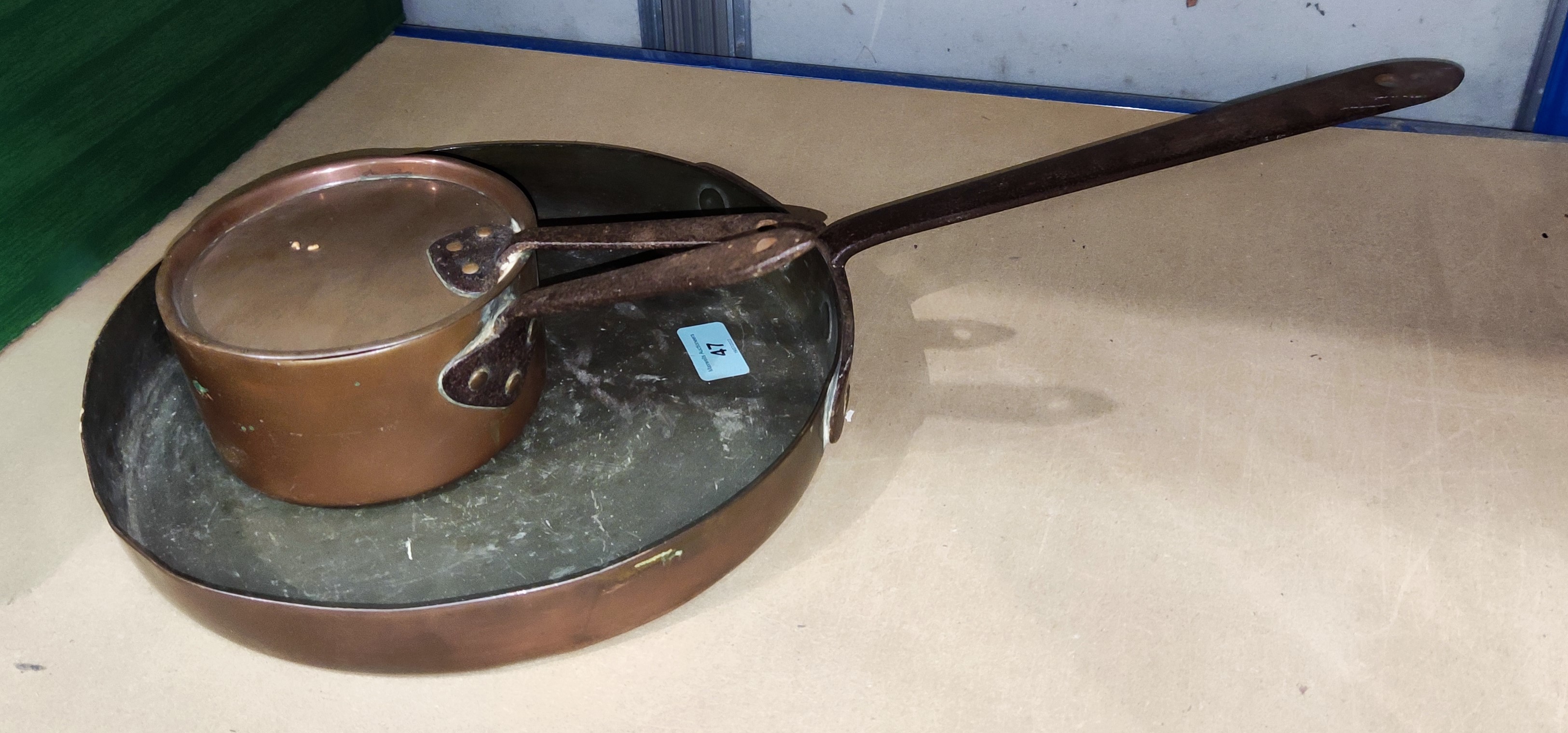 A vintage copper frying pan, a similar saucepan, bellowing pipes etc
