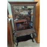 A late 19th century carved Chinese display cabinet with bamboo effect stepped shelves and