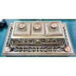 A 19th century brass double desk set with inkwells and central stamp section under hinged lids, with