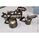 Four vintage graduating brass blow lamps