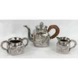 An early - mid Chinese, 3 piece white metal tea set of square form, planished with raised dragon