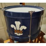A marching drum in blue with Prince of Wales's feathers painted on the front