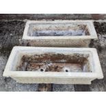 A pair of reconstituted stone garden troughs