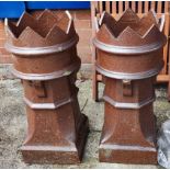 A pair of brown crown top chimney pots