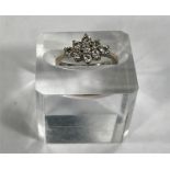 An 18 carat gold dress ring set 9 diamonds in floral arrangement, stones approx. 3mm diameter, 3.9gm
