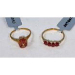 A gold dress ring set with 4 oval Songea rubies (0.94 carats) interspersed with small white