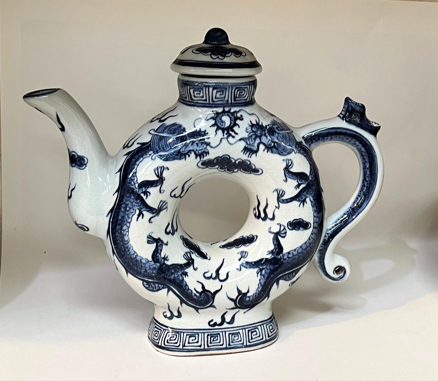 A Chinese blue and white teapot with central hole and 4 character mark to base. Height A Stone