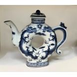 A Chinese blue and white teapot with central hole and 4 character mark to base. Height A Stone