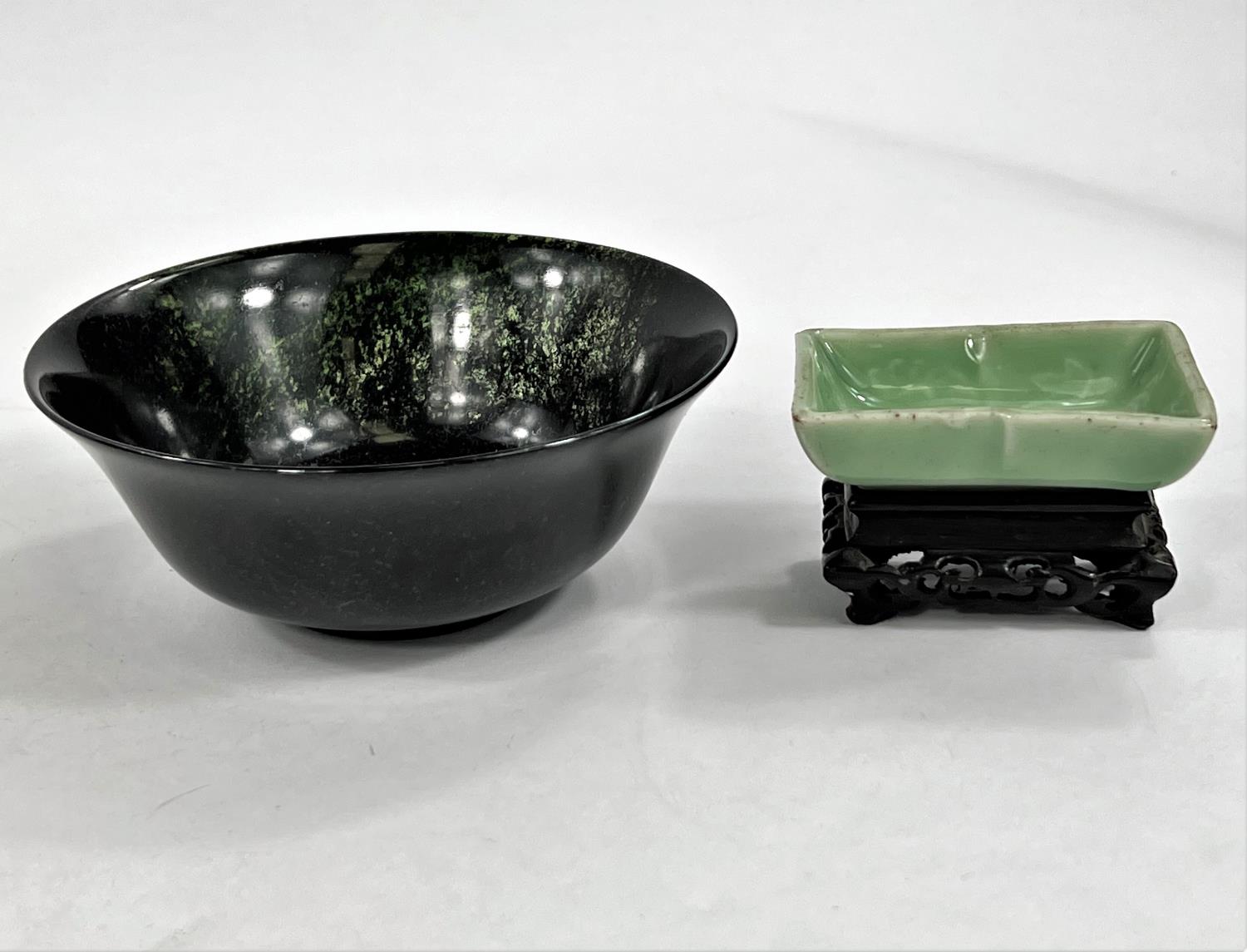 A Chinese carved hardstone bowl dia. 13cm and a Celadon coloured bowl on wooden stand