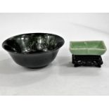 A Chinese carved hardstone bowl dia. 13cm and a Celadon coloured bowl on wooden stand