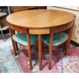 A 1960's Danish teak dining suite comprising circular table and 4 wedge shaped chairs