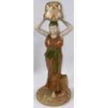 A late 19th/early 20th century Royal Worcester figure of a female water carrier, her arms holding